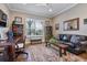 Comfortable living room with a black leather sofa, wooden desk, and a patterned rug at 17213 Bullhorn Cir, Punta Gorda, FL 33982