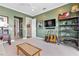 Spacious living room featuring modern decor, a TV, guitars, and comfortable seating at 17213 Bullhorn Cir, Punta Gorda, FL 33982