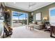 Green living room featuring a comfortable sofa, guitars, and sliding doors with a lake view at 17213 Bullhorn Cir, Punta Gorda, FL 33982