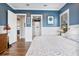 Stylish main bedroom featuring a blue painted wall, wood floors, slider doors, and neutral accents at 17213 Bullhorn Cir, Punta Gorda, FL 33982
