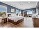 Stylish main bedroom featuring a wood bed frame, wood floors, slider doors, and neutral blue walls at 17213 Bullhorn Cir, Punta Gorda, FL 33982