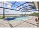 A spacious pool and spa area with a screened enclosure and stunning views of the lake at 17213 Bullhorn Cir, Punta Gorda, FL 33982