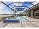 Screened-in pool with lake views, offering a luxurious outdoor retreat with integrated spa and lounge chairs at 17213 Bullhorn Cir, Punta Gorda, FL 33982