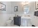 Stylish powder room featuring wainscoting, a pedestal sink, and elegant decor for a modern touch at 17213 Bullhorn Cir, Punta Gorda, FL 33982