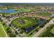 Aerial view of the neighborhood showcasing the lake, trees and nearby golf course at 181 Padova Way # 19, Nokomis, FL 34275