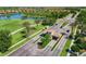 An aerial view of a gated community entrance, showcasing the lush landscaping, lake, and well-maintained roads at 181 Padova Way # 19, Nokomis, FL 34275