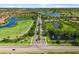 Beautiful aerial view of neighborhood showcasing golf course, lakes, roads and trees at 181 Padova Way, Nokomis, FL 34275
