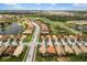 Expansive aerial view showcasing the neighborhood, a community with lush landscaping and serene lakes at 181 Padova Way # 19, Nokomis, FL 34275