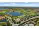 Beautiful aerial view of the community, showcasing the lake, golf course and surrounding wooded area at 181 Padova Way # 19, Nokomis, FL 34275