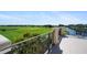 Balcony featuring decorative iron railing and a view of a verdant golf course and pond at 181 Padova Way # 19, Nokomis, FL 34275
