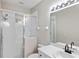 Clean, well-lit bathroom features a glass-enclosed shower, modern fixtures, and neutral tones at 181 Padova Way # 19, Nokomis, FL 34275