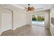 Bright room with wood floors and sliding glass doors to a pool at 181 Padova Way # 19, Nokomis, FL 34275