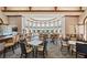 Spacious clubhouse lounge area with elegant seating, a full bar, and large windows providing abundant natural light at 181 Padova Way # 19, Nokomis, FL 34275