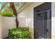 Charming courtyard entrance with lush tropical foliage, creating a private and inviting atmosphere at 181 Padova Way # 19, Nokomis, FL 34275