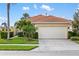 Charming single-story home with a two-car garage, tropical landscaping, and a red tile roof at 181 Padova Way # 19, Nokomis, FL 34275