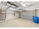 Spacious garage with high ceilings and overhead storage racks, offering ample space at 181 Padova Way # 19, Nokomis, FL 34275