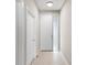Hallway with white doors and tile flooring at 181 Padova Way # 19, Nokomis, FL 34275