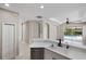 Bright kitchen features stainless steel appliances, breakfast bar, and seamless connection to living area at 181 Padova Way # 19, Nokomis, FL 34275