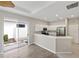 Modern kitchen featuring stainless steel appliances, ample white cabinetry, and an open design at 181 Padova Way # 19, Nokomis, FL 34275