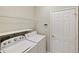 Convenient laundry room with modern washer, dryer, and wire shelving for storage at 181 Padova Way # 19, Nokomis, FL 34275
