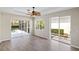 Spacious main bedroom features hardwood floors, a ceiling fan, and sliding glass doors at 181 Padova Way # 19, Nokomis, FL 34275