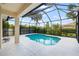 Inviting screened-in pool provides a refreshing retreat with lush landscaping for privacy at 181 Padova Way # 19, Nokomis, FL 34275
