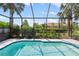 Sparkling pool featuring a screened enclosure and lush tropical landscaping at 181 Padova Way # 19, Nokomis, FL 34275