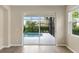 View of the pool through the sliding glass doors at 181 Padova Way # 19, Nokomis, FL 34275