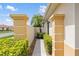 Attractive walkway leading to the entrance, framed by lush landscaping and charming columns at 181 Padova Way # 19, Nokomis, FL 34275