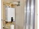 Tankless water heater for on demand hot water, energy efficient unit on the wall at 181 Padova Way, Nokomis, FL 34275