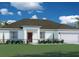 Charming single-story home with a well-maintained lawn and welcoming front entrance at 1837 Rada Ln, North Port, FL 34288