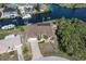 Attractive home with a charming paver driveway, garage, canal access, and lush palm tree landscaping at 18602 Ashcroft Cir, Port Charlotte, FL 33948