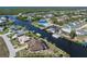 Aerial view of the property showcases its canal-front location, proximity to waterways, and surrounding neighborhood at 18602 Ashcroft Cir, Port Charlotte, FL 33948