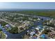 Waterfront property aerial view, highlighting its access to a wide waterway and the surrounding neighborhood, near expansive waterways at 18602 Ashcroft Cir, Port Charlotte, FL 33948