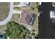 Overhead view of a waterfront home with a screened-in lanai, situated by a canal for boating at 18602 Ashcroft Cir, Port Charlotte, FL 33948