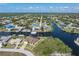 Waterfront home with a beautiful canal view, boat dock, and lush tropical landscaping in a vibrant neighborhood at 18602 Ashcroft Cir, Port Charlotte, FL 33948