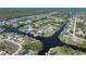 An aerial view of the property highlighting its canal front location within a coastal neighborhood and nearby waterways at 18602 Ashcroft Cir, Port Charlotte, FL 33948