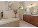 Bathroom features soaking tub, granite counters, and neutral earth tone tile at 18602 Ashcroft Cir, Port Charlotte, FL 33948