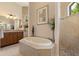 Soaking tub featured in well-appointed primary bathroom with granite counters at 18602 Ashcroft Cir, Port Charlotte, FL 33948
