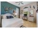 This bedroom is decorated with coastal decor and has a ceiling fan and neutral tile floors at 18602 Ashcroft Cir, Port Charlotte, FL 33948