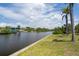 Scenic view of a tranquil canal lined with lush vegetation, and beautiful waterfront homes at 18602 Ashcroft Cir, Port Charlotte, FL 33948