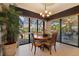 Dining area with pool views and a stylish chandelier at 18602 Ashcroft Cir, Port Charlotte, FL 33948