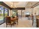 Well-lit dining room with a wooden table next to a large sliding glass door with a view of the pool at 18602 Ashcroft Cir, Port Charlotte, FL 33948