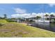 Waterfront property featuring a boat dock, a sailboat and canal access to open water at 18602 Ashcroft Cir, Port Charlotte, FL 33948