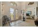 Elegant foyer featuring decorative glass doors, neutral tile flooring, and classic decor at 18602 Ashcroft Cir, Port Charlotte, FL 33948