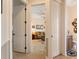 Open hallway view into the living room and bathroom with tile floors and storage at 18602 Ashcroft Cir, Port Charlotte, FL 33948