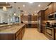 Gourmet kitchen featuring stainless appliances, granite countertops, wood cabinets, and an eat-in bar at 18602 Ashcroft Cir, Port Charlotte, FL 33948