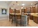 This kitchen features granite countertops, stainless steel appliances, and custom cabinetry and bar with seating at 18602 Ashcroft Cir, Port Charlotte, FL 33948