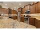 Well-equipped kitchen with stainless steel appliances, granite countertops, and ample cabinetry at 18602 Ashcroft Cir, Port Charlotte, FL 33948