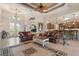 An open-concept living room features a decorative ceiling, tile floors, leather sofas, and stylish furnishings at 18602 Ashcroft Cir, Port Charlotte, FL 33948